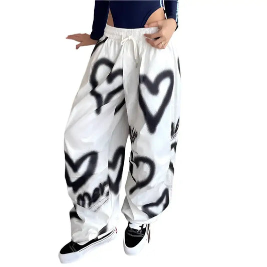 White baggy heart pants with black heart graffiti designs, perfect for Y2K style