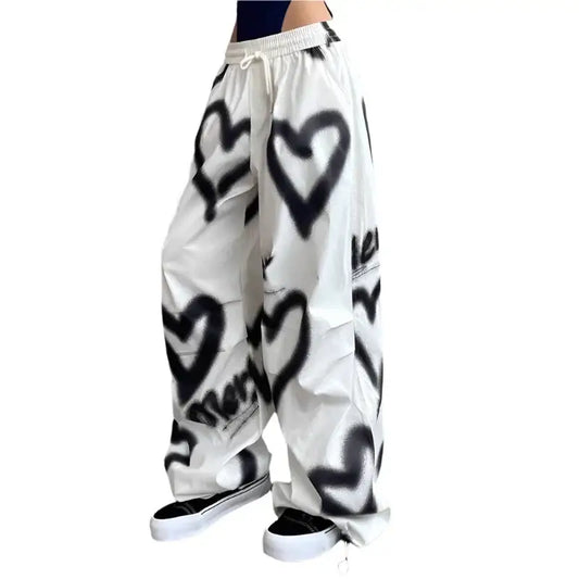 Wide-leg white Heart Pants with trendy black spray-painted heart designs for a Y2K vibe