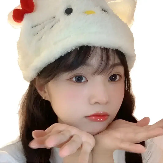 Person wearing a cute Hello Kitty Beanie made of plush material with a red bow