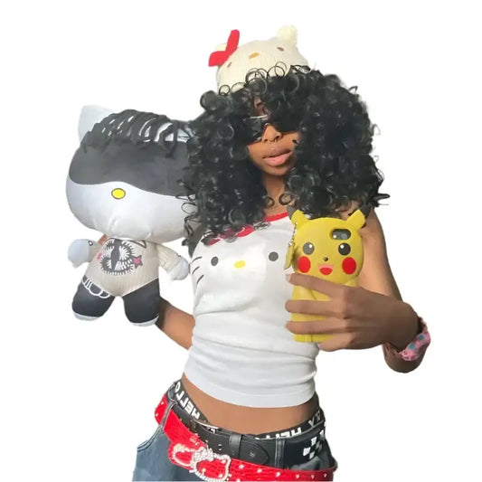 Person in a Hello Kitty-themed shirt holding plush toys featuring Y2K style kitty crop