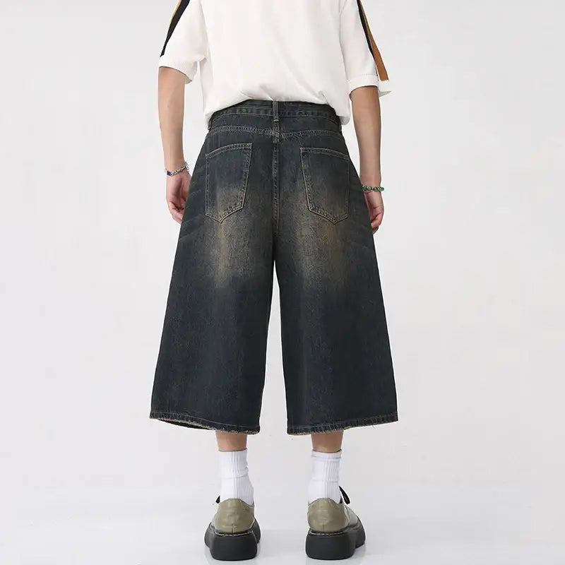 Wide-leg denim culottes styled with white socks and chunky sneakers from Jorts Baggy Y2K