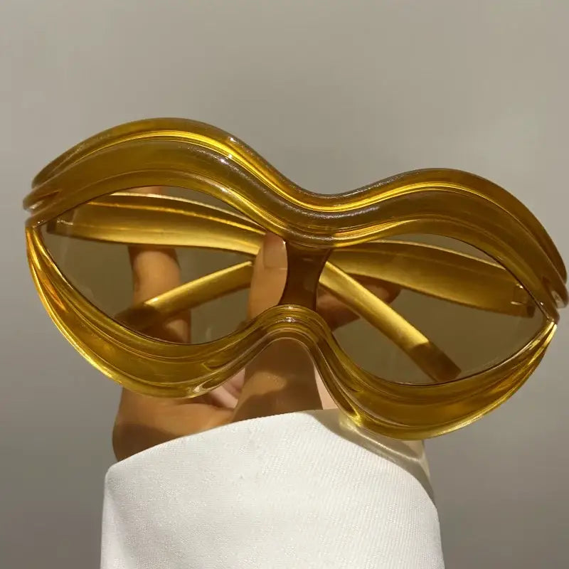 Oversized golden Lip Sunglasses with wavy frames for a trendy Y2K look