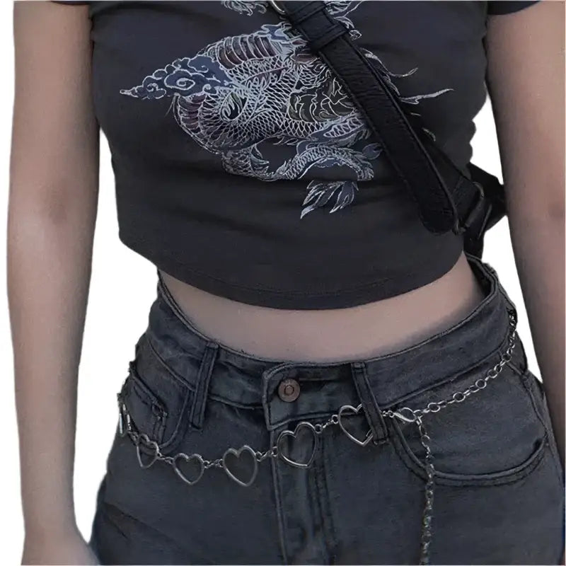 Heart-shaped chain belt styled over dark jeans featuring a Metal Heart Belt design