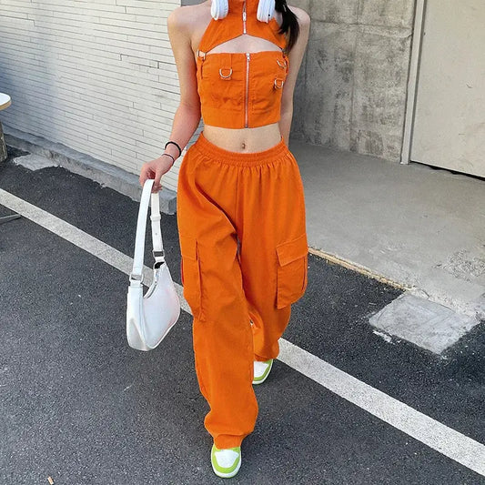 Bright orange two-piece outfit with cropped halter top and baggy cargo pants