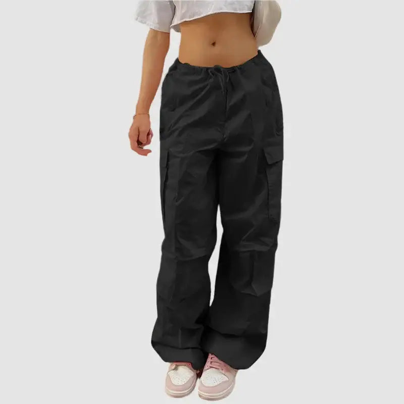 Black cargo pants featuring multiple pockets and a loose fit, ideal for styling with pink cargo