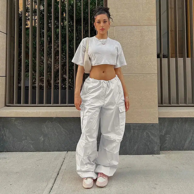 Woman in white crop top and baggy pants showcasing stylish Pink Cargo Pants