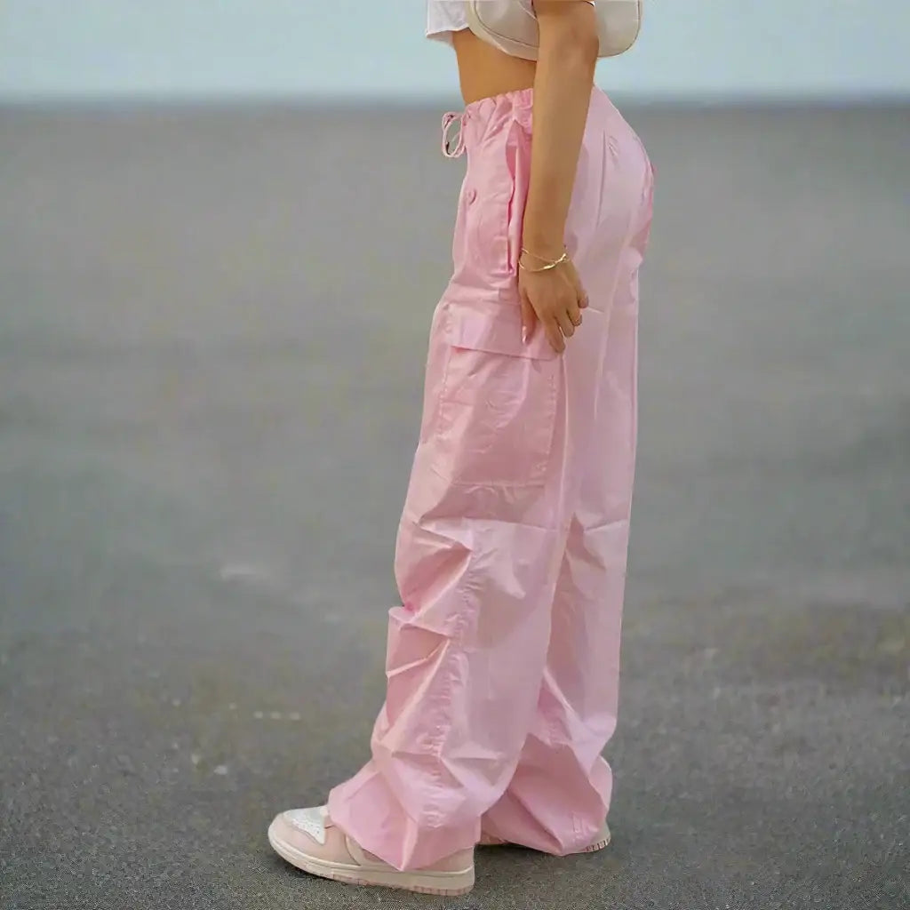 Pink cargo pants featuring a drawstring waist and wide-leg design for stylish comfort