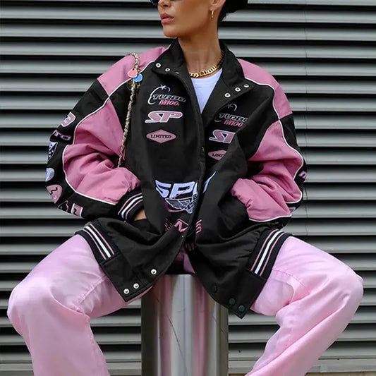 Racing-style black and pink moto jacket featuring logos and patches for a stylish look