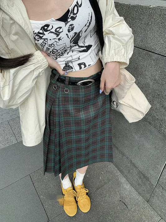 Plaid midi skirt styled with a graphic crop top and cream-colored jacket