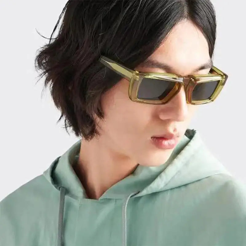 Stylish Punk Square Sunglasses with gold frame worn by a person in mint green hoodie