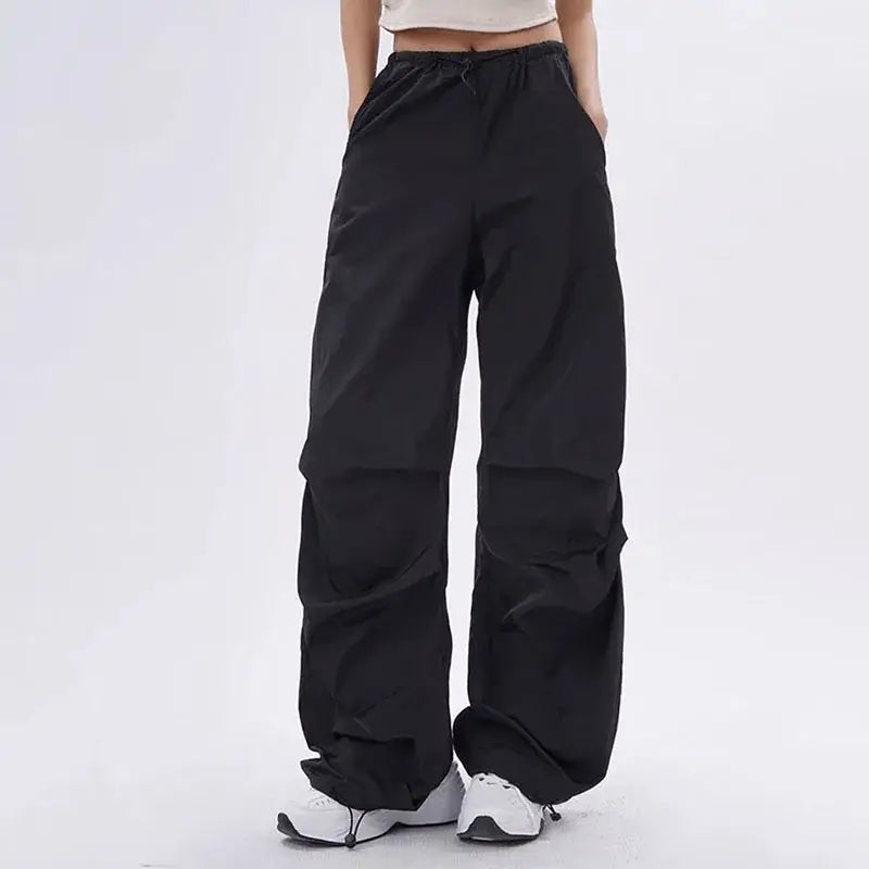 Black wide-leg elastic waistband trousers with side pockets for purple parachute pants