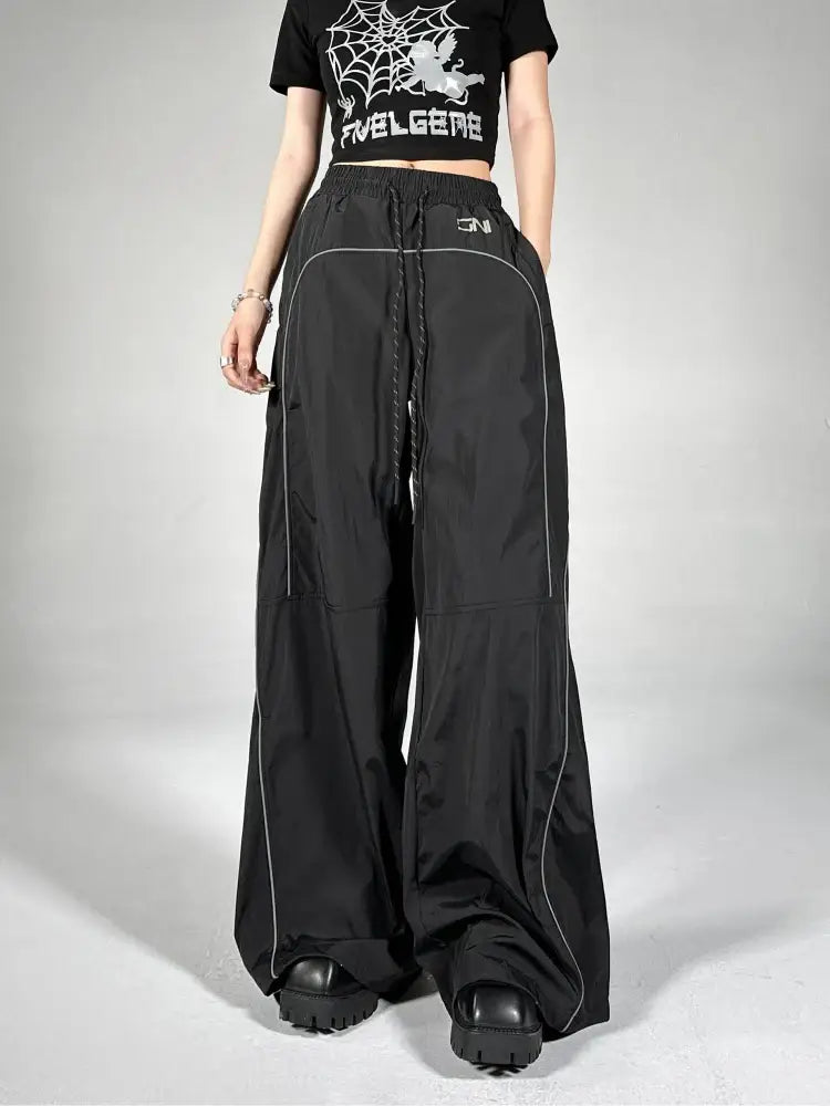 Wide-leg black Reflective Parachute Pants with drawstring waist and side piping