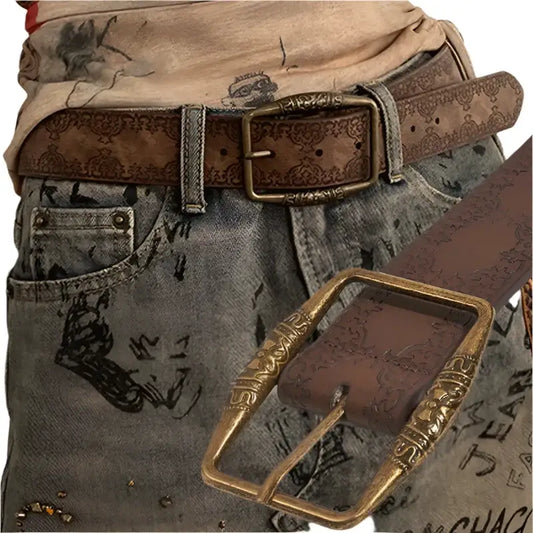 Worn leather belt with brass buckle on faded denim jeans for a retro belt buckle look