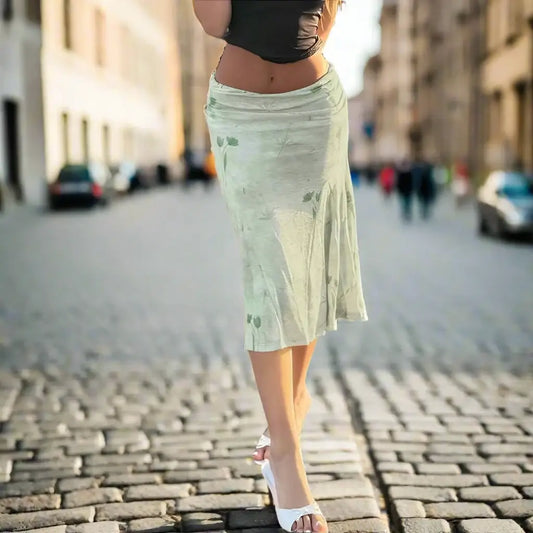 Pale green floral midi skirt on a cobblestone street showcasing retro floral style