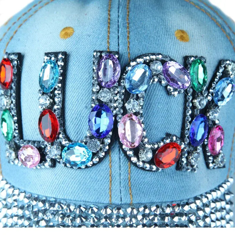 Bejeweled denim rhinestone cap with colorful gemstones spelling LUCK in Y2K style