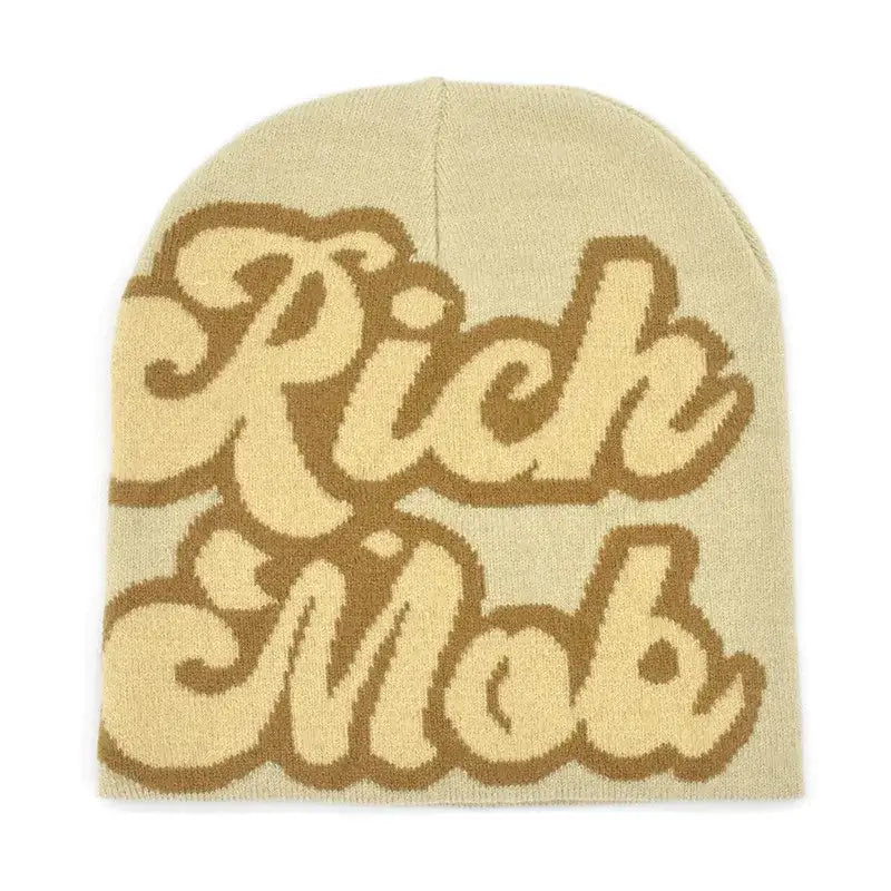 Beige Rich Mob Beanie featuring brown lettering for a stylish winter accessory