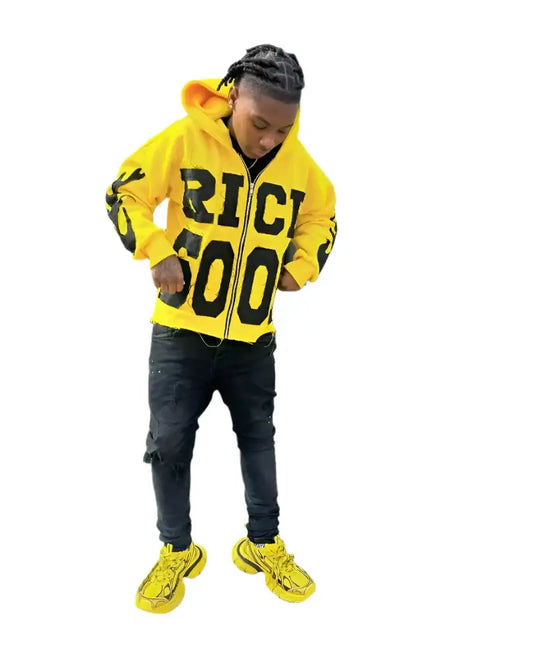 Person in a bright yellow RICI 500 hoodie and sneakers showcasing Y2K style design makes