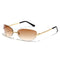 Rimless sunglasses with gold frames and gradient brown lenses showcasing Y2K style