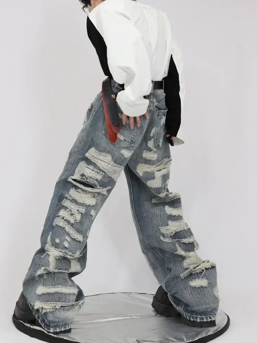 Pair of heavily distressed baggy Ripped Jeans Men worn by a model