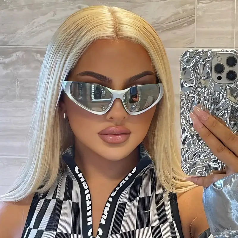 Woman with long blonde hair in oversized silver glasses Y2K and a checkered top