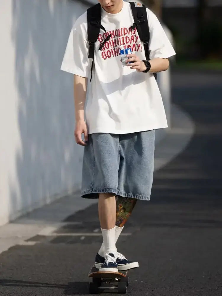 Person skateboarding in skater jorts, casual white t-shirt, and a backpack