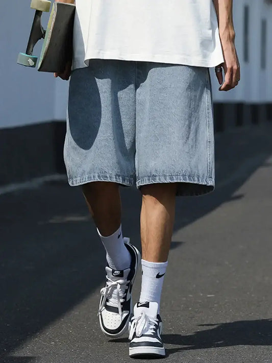 Wide-leg denim shorts styled with white sneakers and socks, perfect Y2K skater jorts