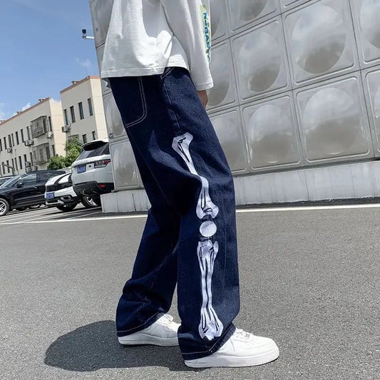 Skeleton Jeans featuring a white skeletal leg design on dark blue denim for a Y2K style