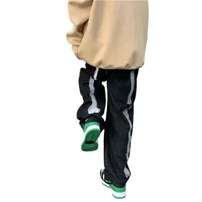 Black Skeleton Pants Jeans with white side stripes and green-soled shoes