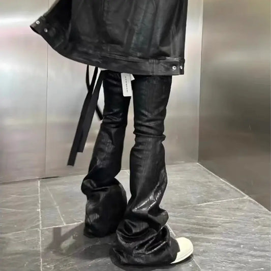 Pair of black leather boots with slouchy shafts styled with Slim Flare Jeans