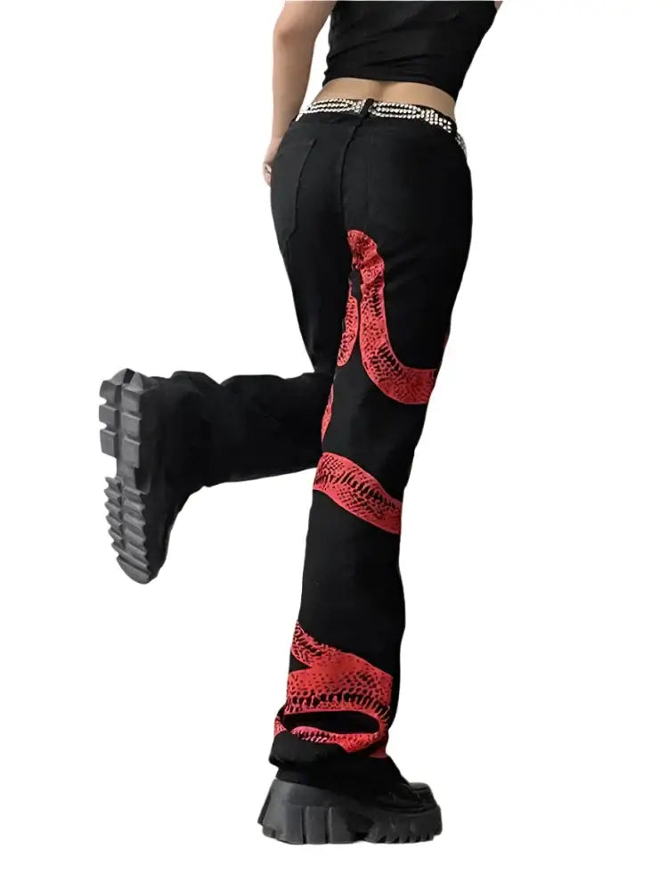 Black snake jeans with red snake design, paired with trendy chunky platform boots