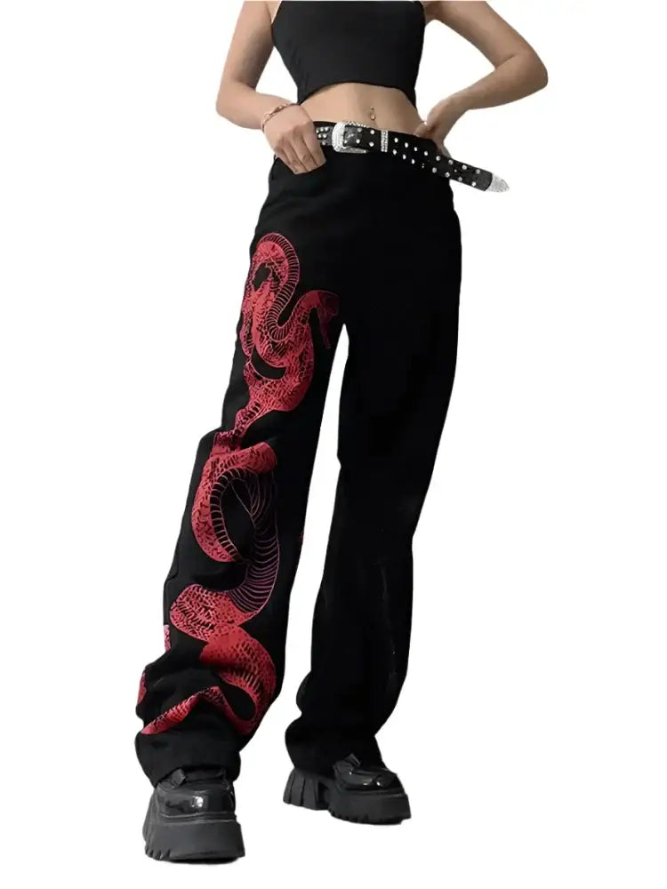 Trendy snake jeans with red dragon design, studded belt, and chunky shoes