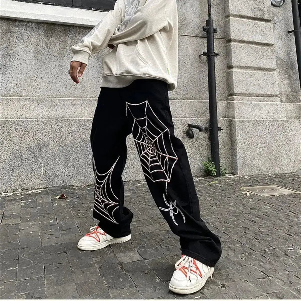 Black Spider Sweatpants featuring white spider web designs, perfect for Y2K clothing men