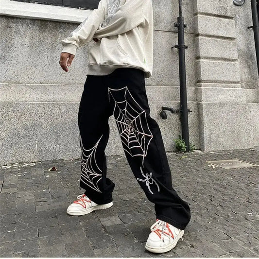 Black Spider Sweatpants featuring white spider web designs, perfect for Y2K clothing men