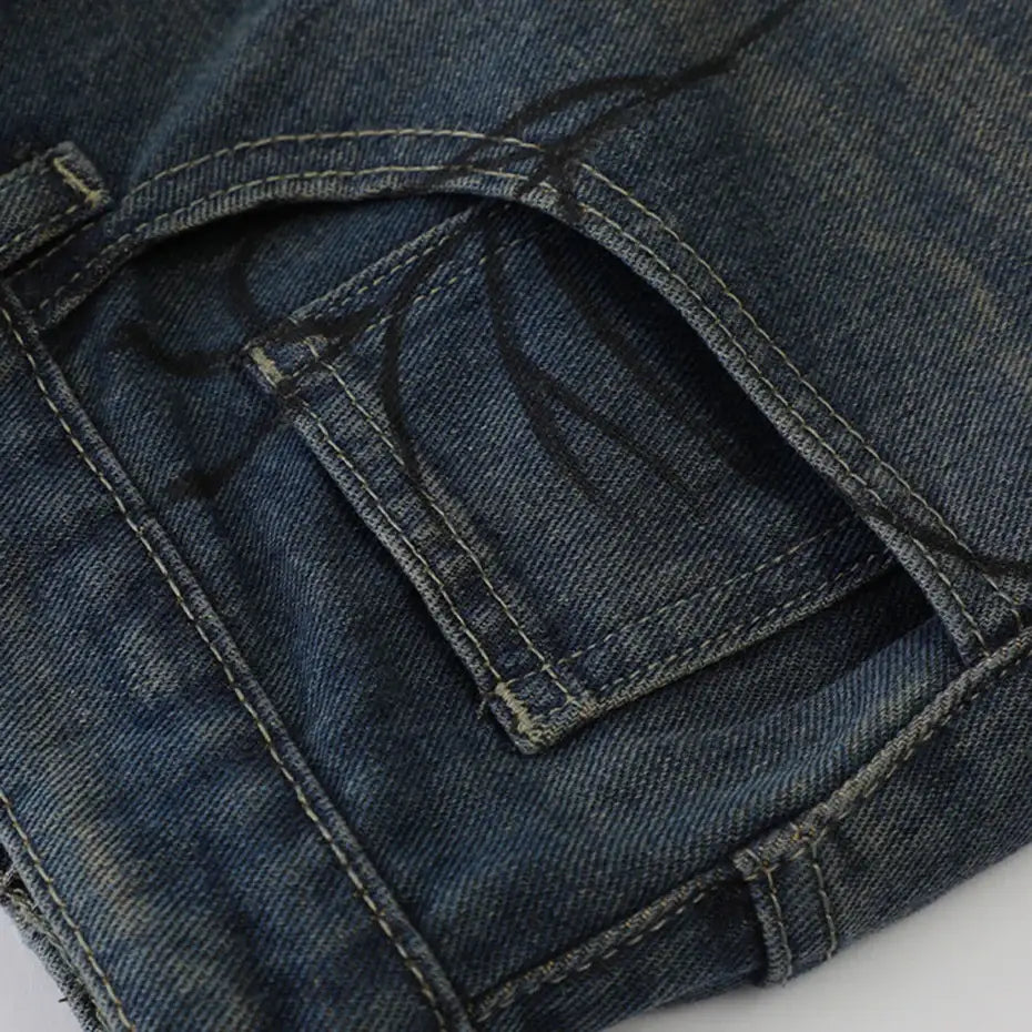 Denim jacket pocket detail with stitching and button closure for Spider Web Shorts