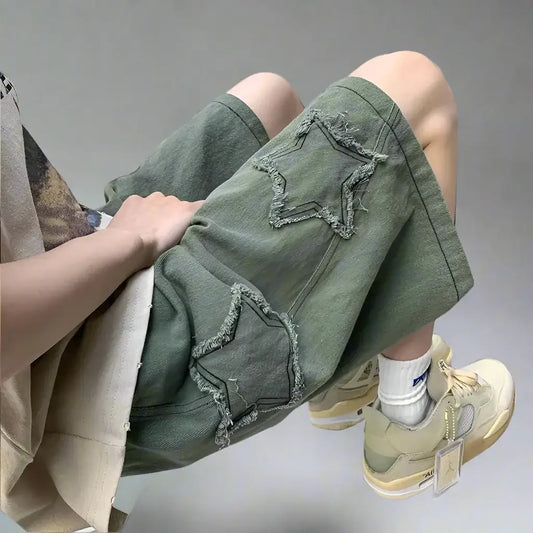 Distressed green Star Shorts featuring frayed star-shaped patches for a comfortable Y2K style