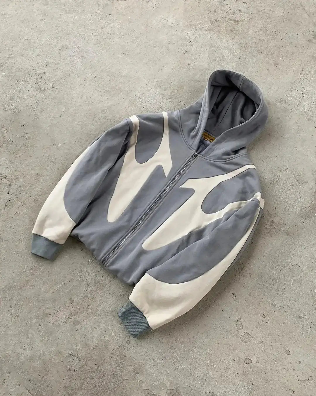 Gray and white patterned streetwear zip hoodie with abstract design in unisex style