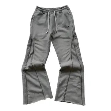 Gray sweat pants with zipper fly, cargo pockets, and drawstring waist perfect for Y2K style