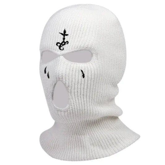 White knitted teardrop ski mask featuring eye and mouth holes with embroidered design