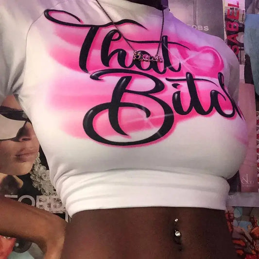 White That Bitch crop top on pink spray-painted background, perfect for Y2K fashion