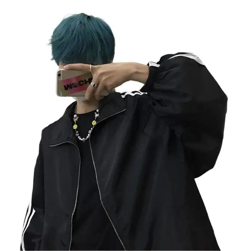 Person with teal hair in a black tracksuit jacket, showcasing the trendiest Y2K style