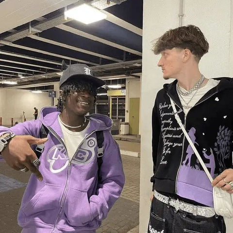 Two young men showcasing Y2K fashion trends in purple hoodie and black jacket.