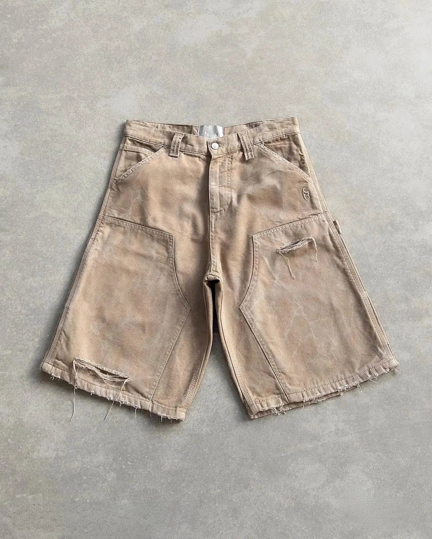 Beige utility cargo shorts with frayed edges and multiple pockets for functionality