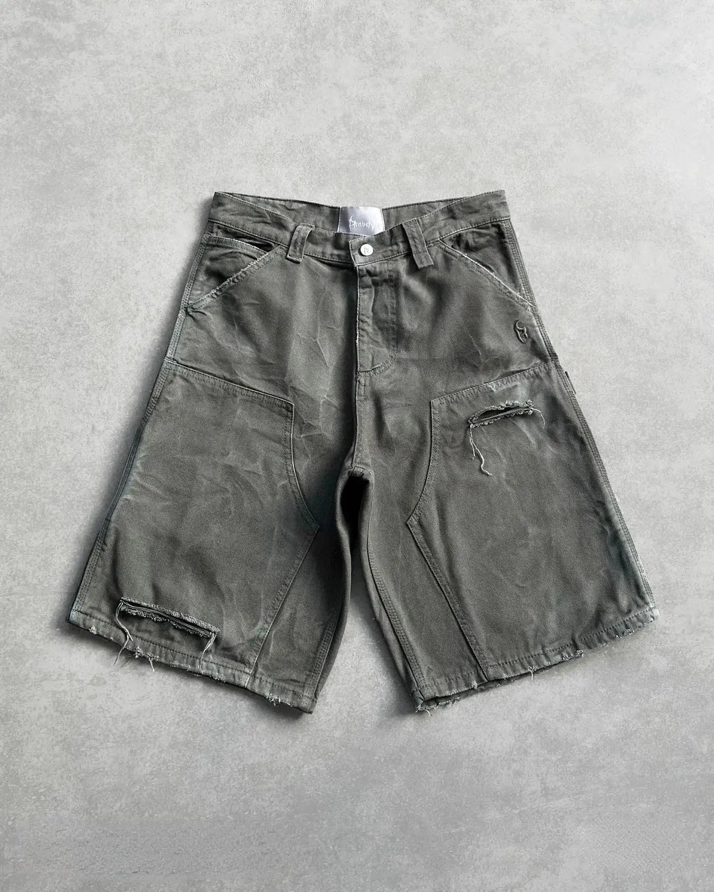 Distressed gray utility cargo shorts featuring prominent wear and tear details