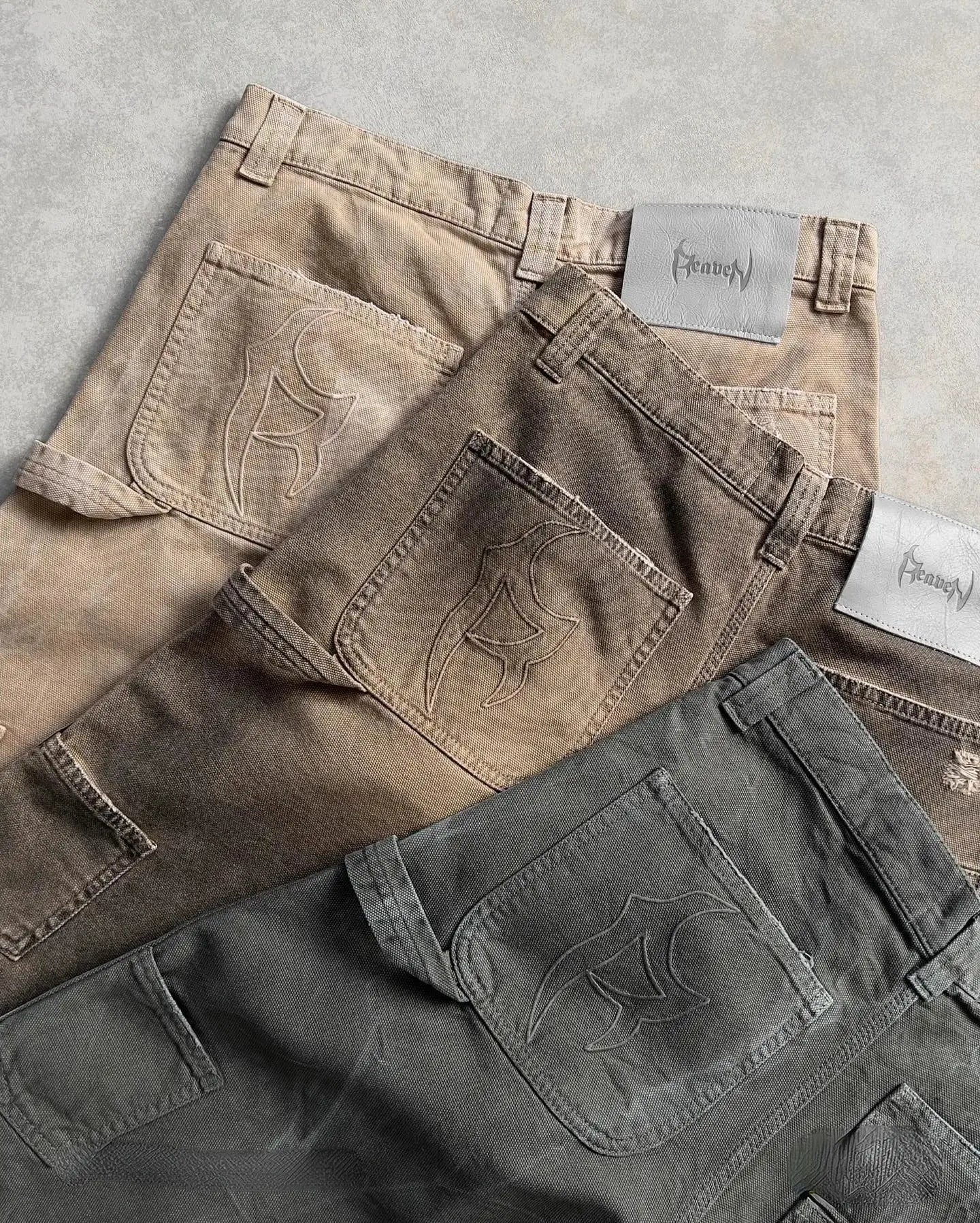 Stack of folded utility cargo shorts in stylish earth-tone colors