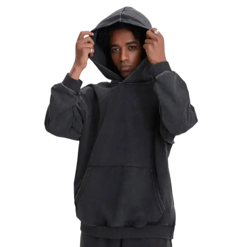 Person adjusting a dark gray Vintage Hoodie, showcasing Y2K fashion style