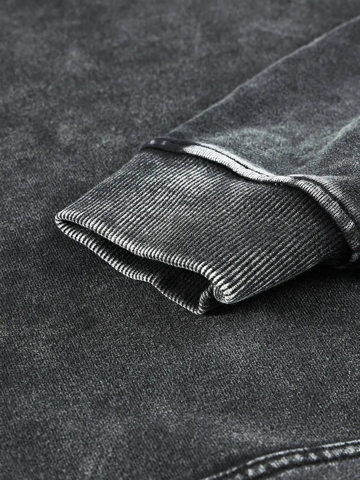 Folded cuff of a dark gray ribbed sleeve from a Vintage Hoodie in Y2K fashion