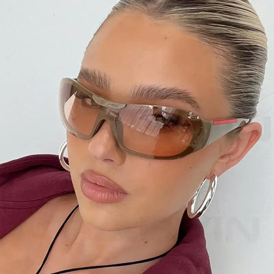 Stylish vintage sunglasses featuring gradient lenses on a person with slicked-back blonde hair