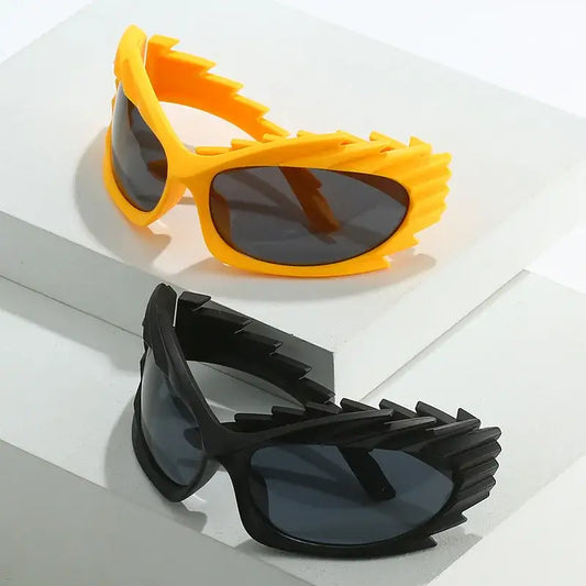 Two pairs of Vortex Sunglasses in yellow and black with jagged frames and lens height