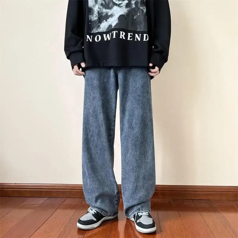 Wide-leg jeans styled with a black sweatshirt and sneakers for a trendy Y2K look