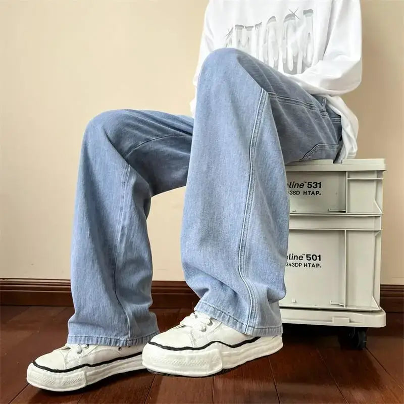 Loose-fitting light blue wide-leg jeans styled with white sneakers for a Y2K look